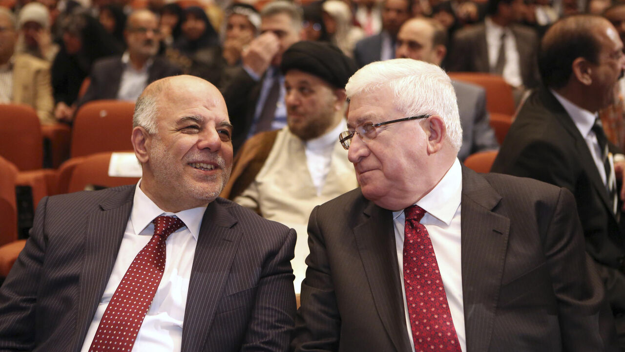 Iraq's new Prime Minister Haider al-Abadi (L) and Iraqi President Fouad Massoum speak during the session to approve the new government in Baghdad, September 8, 2014. Iraq's parliament approved a new government headed by Haider al-Abadi as prime minister on Monday night, in a bid to rescue Iraq from collapse, with sectarianism and Arab-Kurdish tensions on the rise. REUTERS/Hadi Mizban/Pool (IRAQ - Tags: POLITICS) - RTR45G2Z