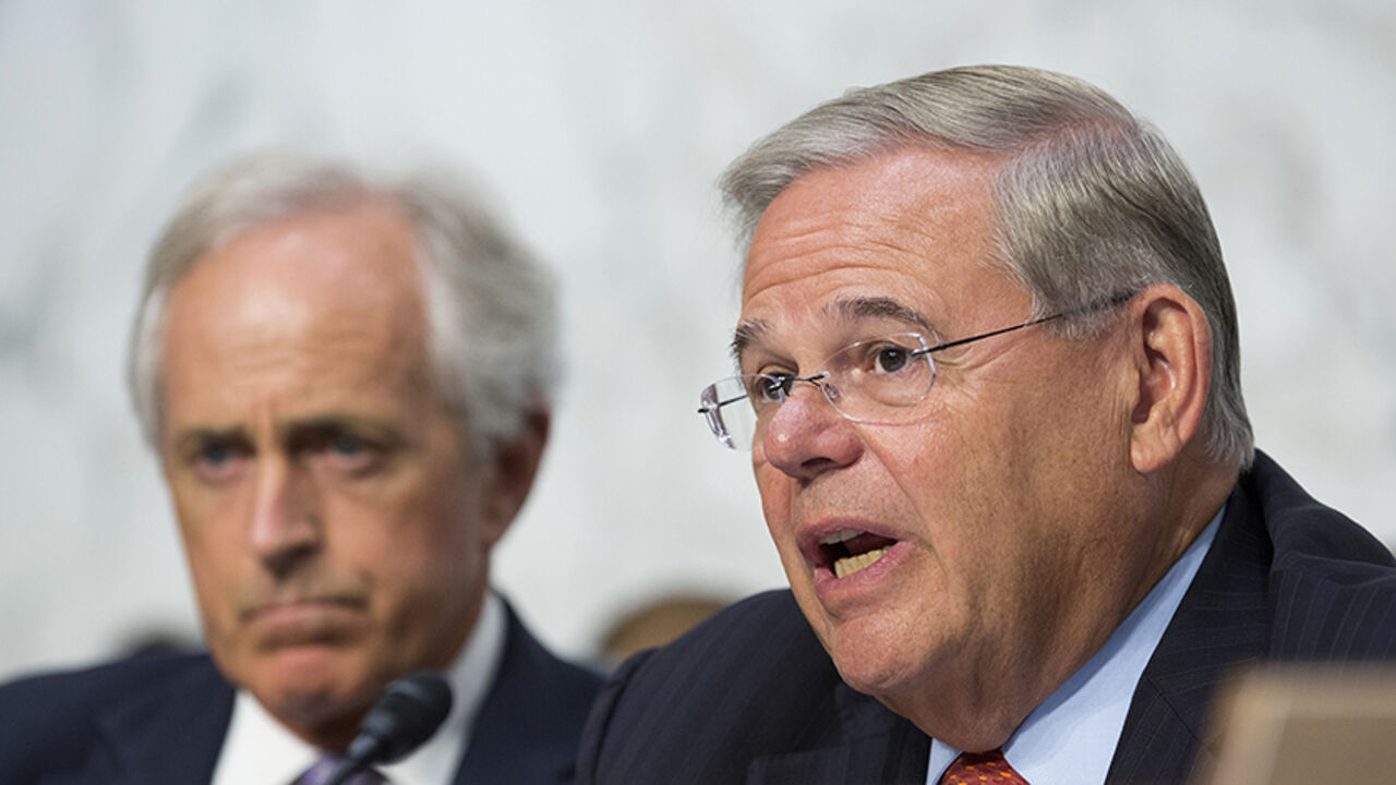 Chairman of the Senate Foreign Affairs Committee Robert Menendez (D-NJ)(R) questions Secretary of State John Kerry as Senator Bob Corker (R-TN) looks on during a hearing on "U.S. Strategy to Defeat the Islamic State in Iraq and the Levant" on Capitol Hill in Washington September 17, 2014.      REUTERS/Joshua Roberts    (UNITED STATES - Tags: POLITICS CIVIL UNREST CONFLICT) - RTR46NIU