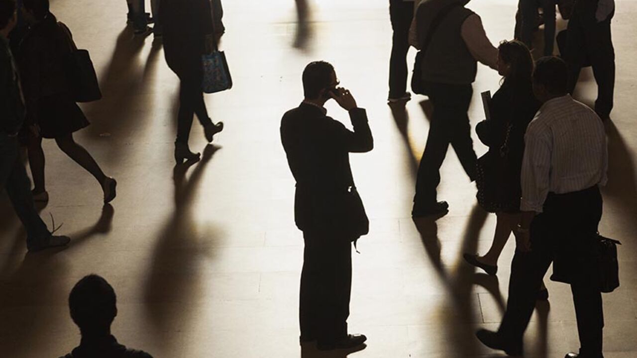 A man stands in the middle of Grand Central Terminal as he speaks on a cell phone, as passengers face limited train service on the New Haven Line between Stamford Station and Grand Central Terminal due to a Con Edison power problem in New York, September 25, 2013. REUTERS/Zoran Milich (UNITED STATES - Tags: TRANSPORT ENERGY TPX IMAGES OF THE DAY) - RTX13Z4Q
