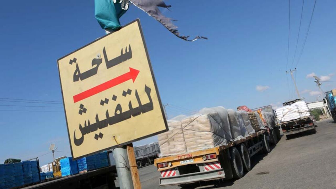 Trucks loaded with bags of cement enter the Gaza Strip from Israel through the Kerem Shalom crossing on October 14, 2014, in Rafah in southern Gaza. International donors pledged about $5.4 billion in aid to the devastated Gaza Strip on October 13, 2014 and urged Israel and the Palestinians to renew peace efforts. AFP PHOTO / SAID KHATIB        (Photo credit should read SAID KHATIB/AFP/Getty Images)