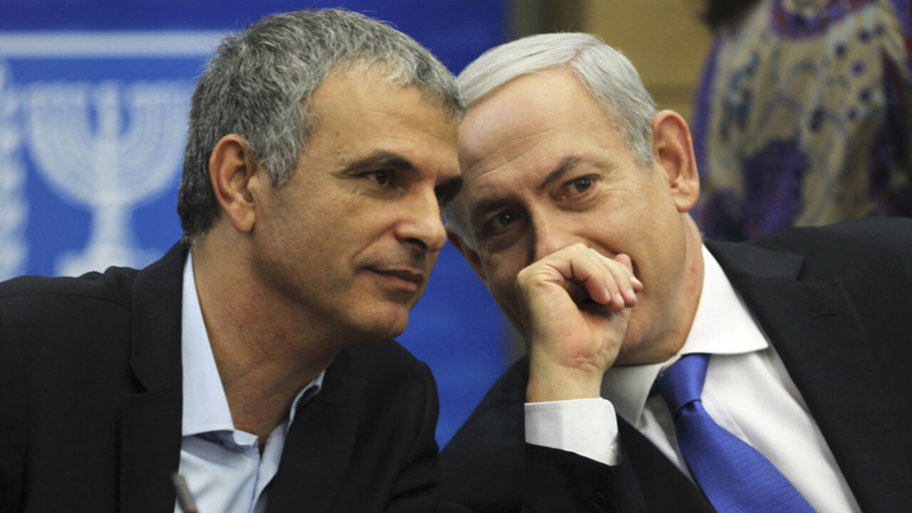 Moshe Kahlon, Israel's Communications and Social Welfare Minister (L) speaks with Prime Minister Benjamin Netanyahu during a Likud party meeting at the Knesset, the Israeli parliament, in Jerusalem October 15, 2012. Netanyahu's Likud party suffered a setback to its popularity on Monday following the announcement by Kahlon, one of the party's best appreciated ministers, that he would step down after an upcoming general election. REUTERS/Baz Ratner (JERUSALEM - Tags: POLITICS) - RTR3966V