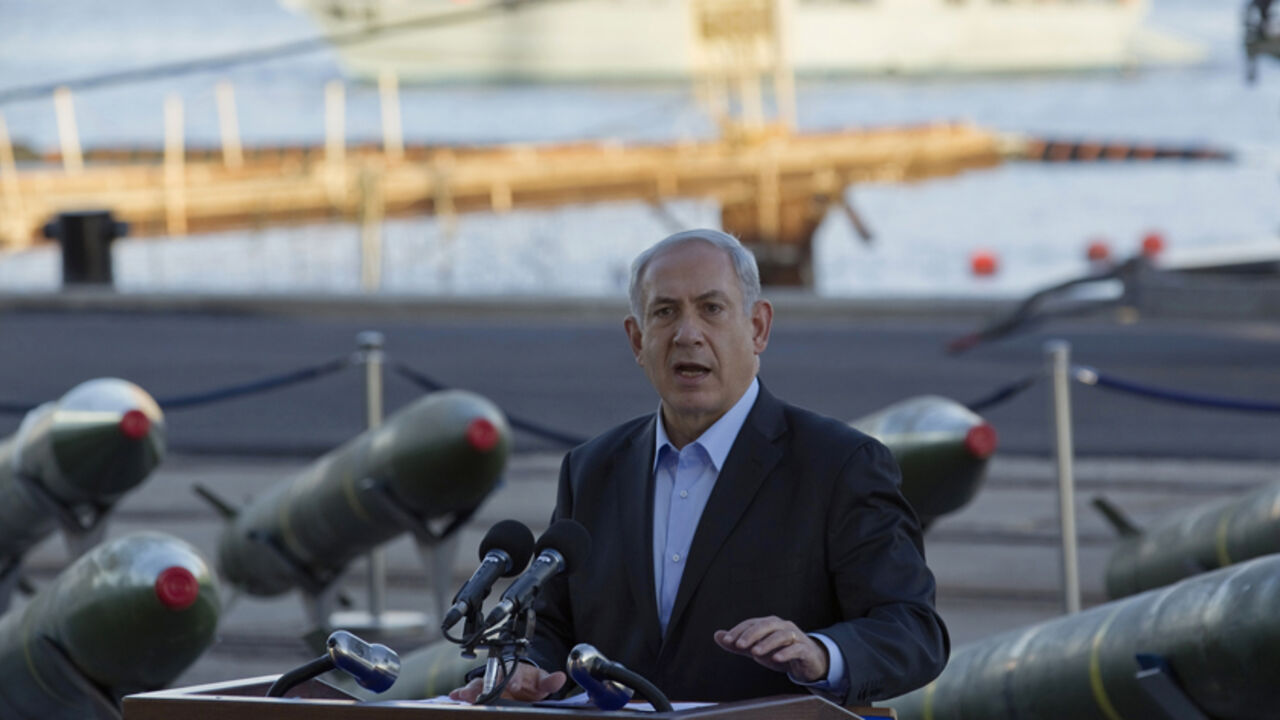 Israel's Prime Minister Benjamin Netanyahu speaks to the media in front of a display of M302 rockets, found aboard the Klos C ship, at a navy base in the Red Sea resort city of Eilat March 10, 2014. Netanyahu, displaying on Monday what Israel said were seized Iranian-supplied missiles bound for militants in Gaza, called on the West not to be fooled by Tehran's diplomatic outreach over its nuclear programme. REUTERS/Amir Cohen (ISRAEL - Tags: POLITICS MILITARY CIVIL UNREST) - RTR3GGS8