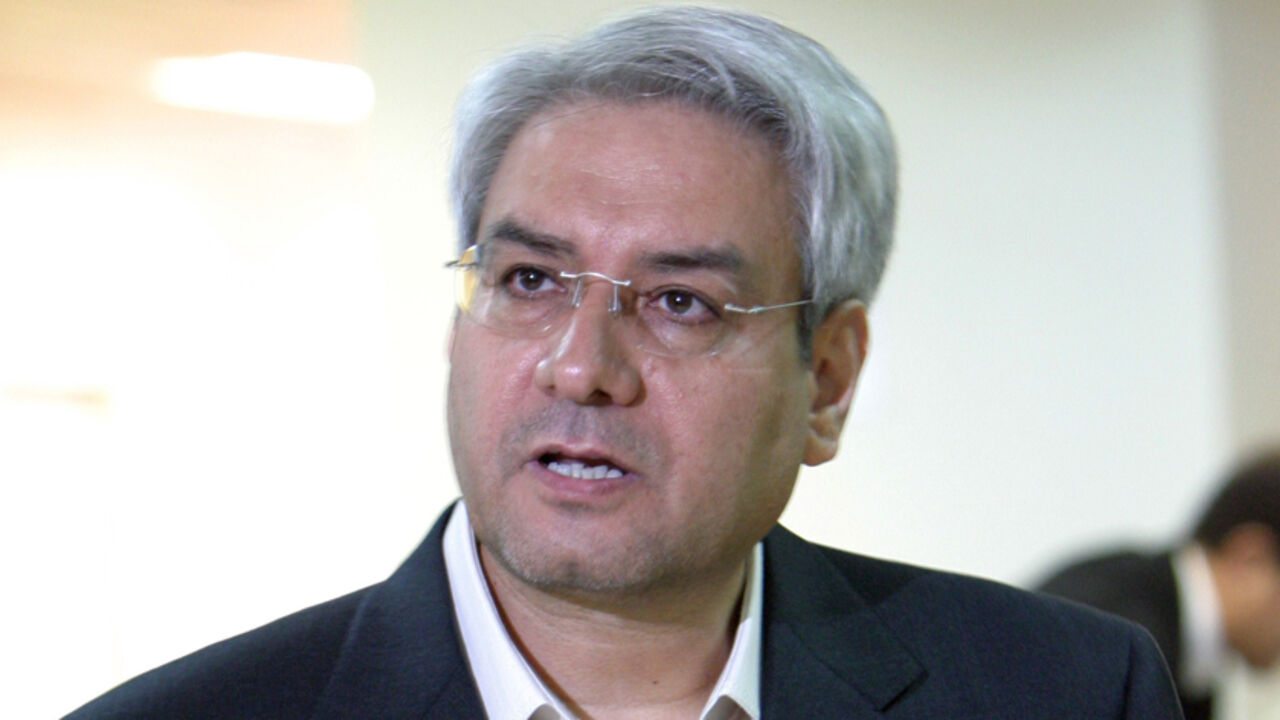 Iranian reformist Ebrahim Asgharzadeh prepares his paperwork to register as a presidential candidate at the Interior Ministry in Tehran.  Iranian reformist Ebrahim Asgharzadeh prepares his paperwork to register as a presidential candidate at the Interior Ministry in Tehran May 14,2005. Candidates began registering on May 10 for Iran's June 17 presidential election. REUTERS/Raheb Homavandi - RTRB4PM