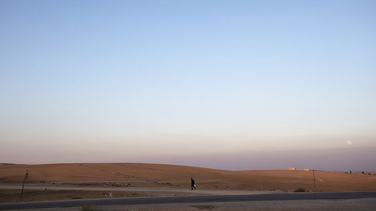 A man walks near the village of al-Sira, one of dozens of ramshackle Bedouin Arab communities in the Negev desert which are not recognised by the Israeli state, in southern Israel August 20, 2013. For decades Arab Bedouins have eked out a meagre existence in the Negev desert, largely under the Israeli government's radar, but now many will have to make way for new developments. Israel has already invested around $5.6 billion to build military bases in the Negev desert and plans to build 10 new communities th