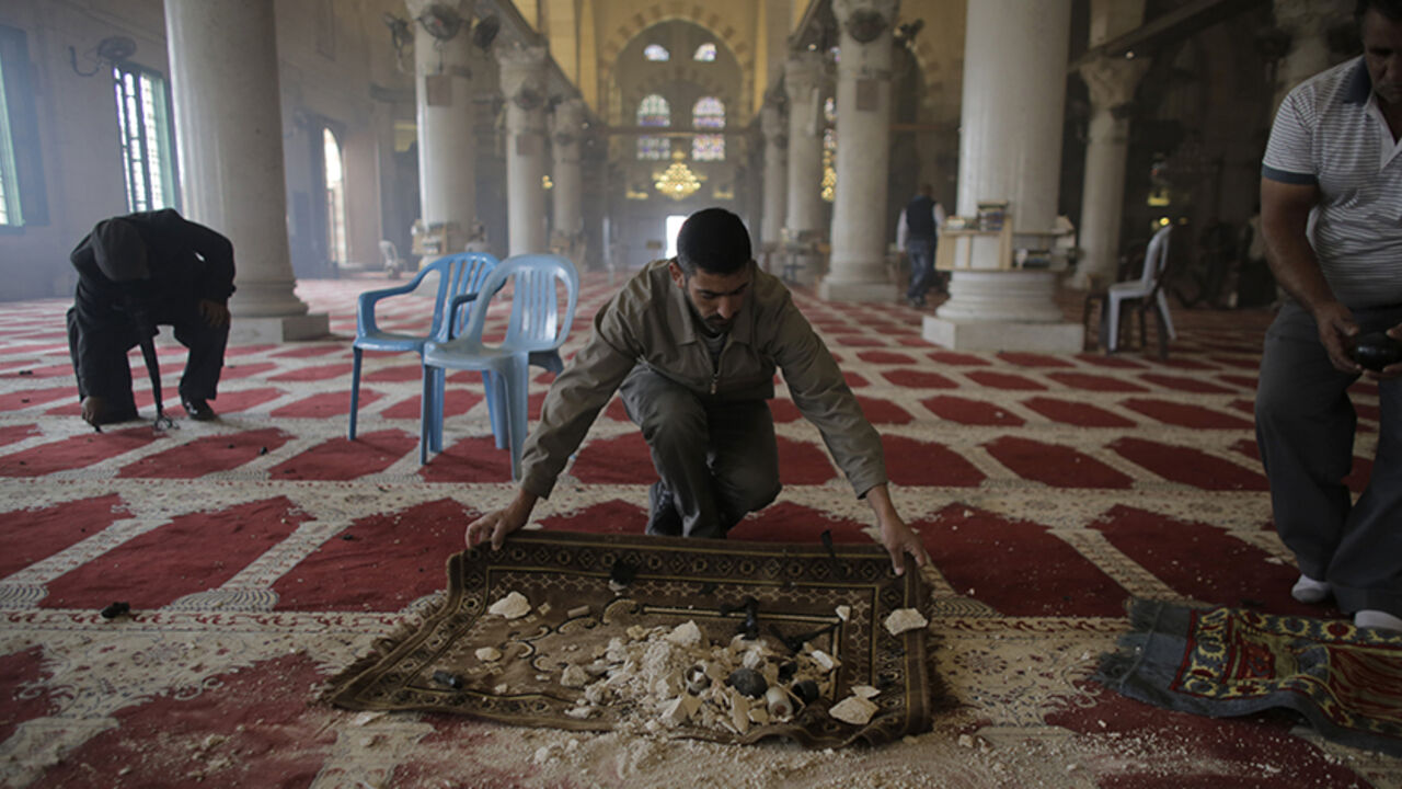 Palestinians clean the Al Aqsa mosque after clashes with Israeli police on the compound known to Muslims as Noble Sanctuary and to Jews as Temple Mount in Jerusalem's Old City November 5, 2014. Israeli security forces hurling stun grenades clashed with Palestinian stone-throwers at al-Aqsa mosque - a confrontation that has played out frequently over the past several weeks. REUTERS/Ammar Awad (JERUSALEM - Tags: POLITICS CIVIL UNREST RELIGION) - RTR4CY3R