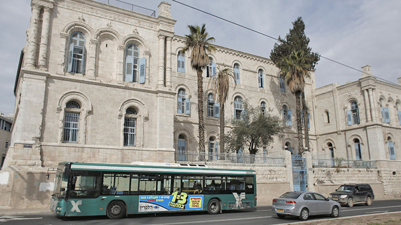 TO GO WITH AFP STORY BY MAJEDA AL-BATSH
A bus owned by Israeli company Egged, the largest bus operating service in Israel passes old buildings in Jerusalem on December 3, 2014. Many Palestinian bus drivers no longer feel safe behind the wheel of Jerusalem's public buses as threats and attacks from Jewish extremists force many to quit their jobs in fear. AFP PHOTO / AHMAD GHARABLI        (Photo credit should read AHMAD GHARABLI/AFP/Getty Images)