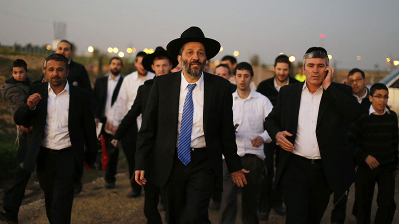 Aryeh Deri (C), leader of the ultra-Orthodox Shas party, attends an annual pilgrimage to the gravesite of Rabbi Yisrael Abuhatzeira, a Moroccan-born sage and kabbalist also known as the Baba Sali, in the southern town of Netivot January 14, 2013.  Powerful political players for years, Israel's ultra-Orthodox parties must now reckon with a new force ushered in by voters bent on stripping them of perks they have relied on for decades. Picture taken January 14, 2013. REUTERS/Amir Cohen (ISRAEL - Tags: POLITICS