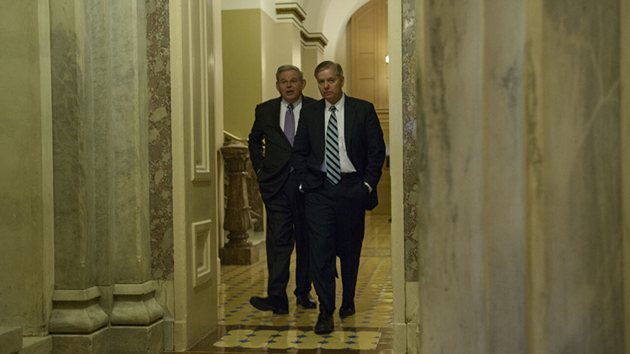 Senator Robert Menendez(L),D-NJ, and Senator Lindsey Graham ,R-SC, walk on Capitol Hill January 6, 2015 in Washington, DC. The 114th Congress convened today with Republicans taking majority control of both the Senate and House of Representatives. AFP PHOTO/BRENDAN SMIALOWSKI        (Photo credit should read BRENDAN SMIALOWSKI/AFP/Getty Images)