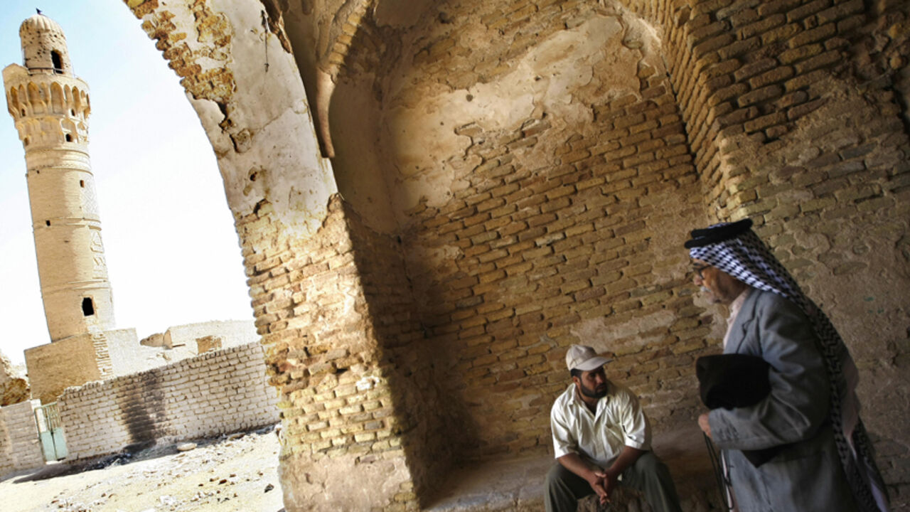 TO GO WITH STORY BY JOSEPH KRAUSS  An Iraqi man leaves an indoor market as he walks towards the 14th-century brick minaret of the Dhu al-Kifl mosque at the site of the Jewish shrine of Ezekiel -- the prophet who followed the Judeans into the Babylonian exile in the 6th century BC -- in the Iraqi town of Kifl, south of Baghdad. Muslims revere nearly all the central religious figures from Judaism and Christianity, including Ezekiel, referred to as Dhu al-Kifl in two Koranic verses and said to have raised the 