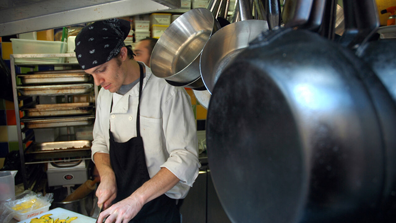 TO GO WITH AFP STORY BY RON BOUSSO
An Israeli cook prepares a dish at the kitchen of "MahneYuda", a recently opened gourmet non-Kosher restaurant, in Jerusalem's landmark Mahne Yehuda market on November 19, 2009. Signs of the changing times can be seen throughout the maze of narrow streets that make up Mahne Yehuda, which is known to locals simply as the "Shuk" -- Hebrew for market. AFP PHOTO/MARINA PASSOS (Photo credit should read MARINA PASSOS/AFP/Getty Images)