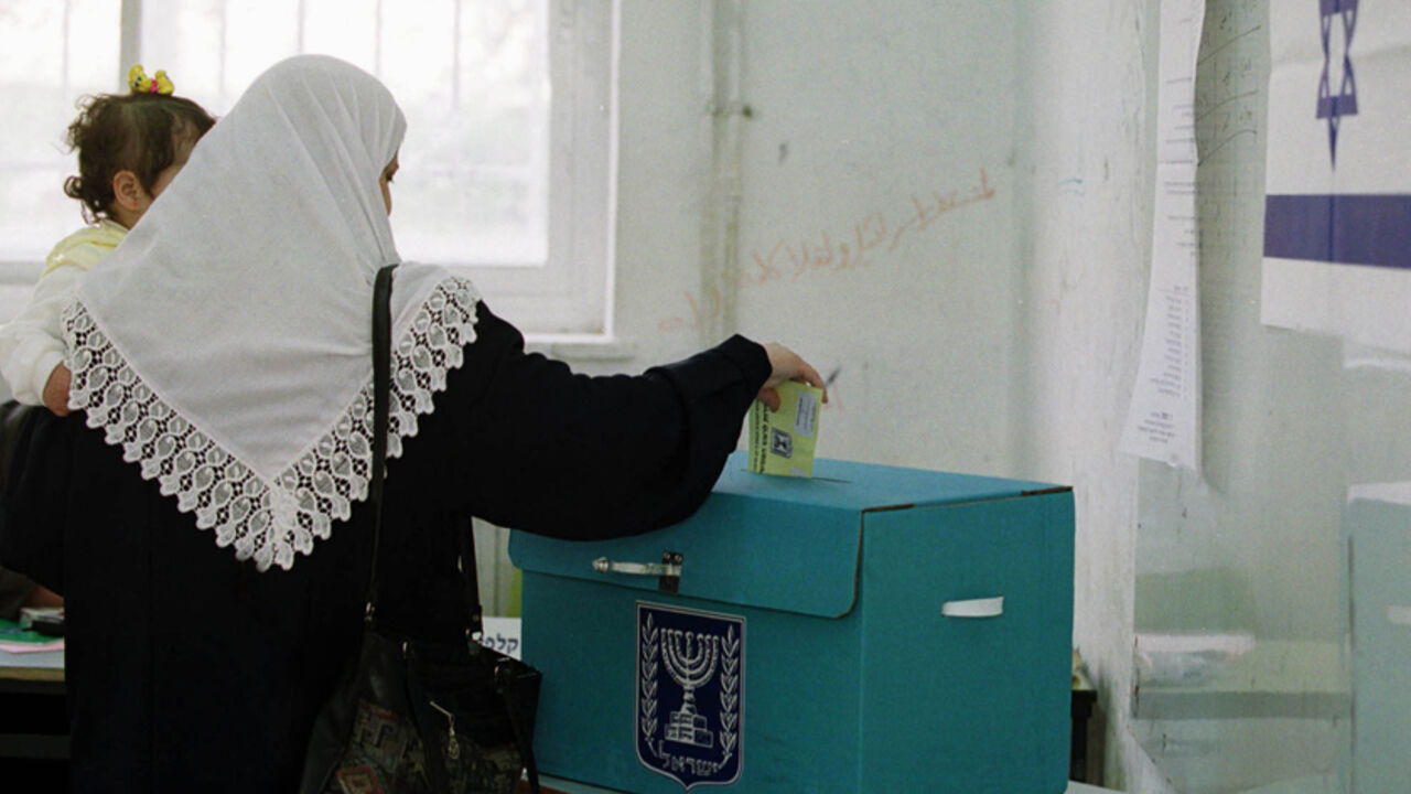 An Israeli-Arab voter drops a ballot into a ballot box during voting in East Jerusalem, February 6, 2001. Most Israeli-Arabs are expected to abstain from voting in a protest against the 13 Israeli-Arabs who were killed during the recent 'Intifada' or uprising against Israel. Ariel Sharon appeared poised for a stunning political victory over Prime Minister Ehud Barak as voters began casting ballots Tuesday in an election seen as a referendum on Israel's relationship with the Palestinians.

EH/WS - RTR15LTJ