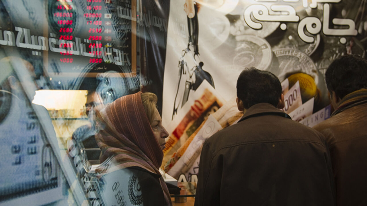 EDITORS' NOTE: Reuters and other foreign media are subject to Iranian restrictions on leaving the office to report, film or take pictures in Tehran.

An Iranian woman stands in a currency exchange shop in northern Tehran January 3, 2012. The Iranian rial fell to a record low against the dollar on Tuesday following U.S. President Barack Obama signing a bill on  imposing fresh sanctions against the country's central bank.    REUTERS/Morteza Nikoubazl (IRAN - Tags: BUSINESS POLITICS) - RTR2VU75