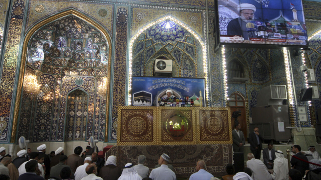 Shi'ite Muslims listen to Sheikh Abdul Mehdi Al-Karbala'i speak as he delivers the text of a sermon by Iraq's top Shi'ite cleric Grand Ayatollah Ali Sistani, during Friday prayers at the Imam Hussein shrine in the holy city of Kerbala July 11, 2014. Sistani urged fighters on Friday to respect the rights of all Iraqis, regardless of sect or politics, after an escalation in apparent sectarian killings in recent weeks. REUTERS/Mushtaq Muhammed (IRAQ - Tags: CIVIL UNREST POLITICS RELIGION) - RTR3Y5N8