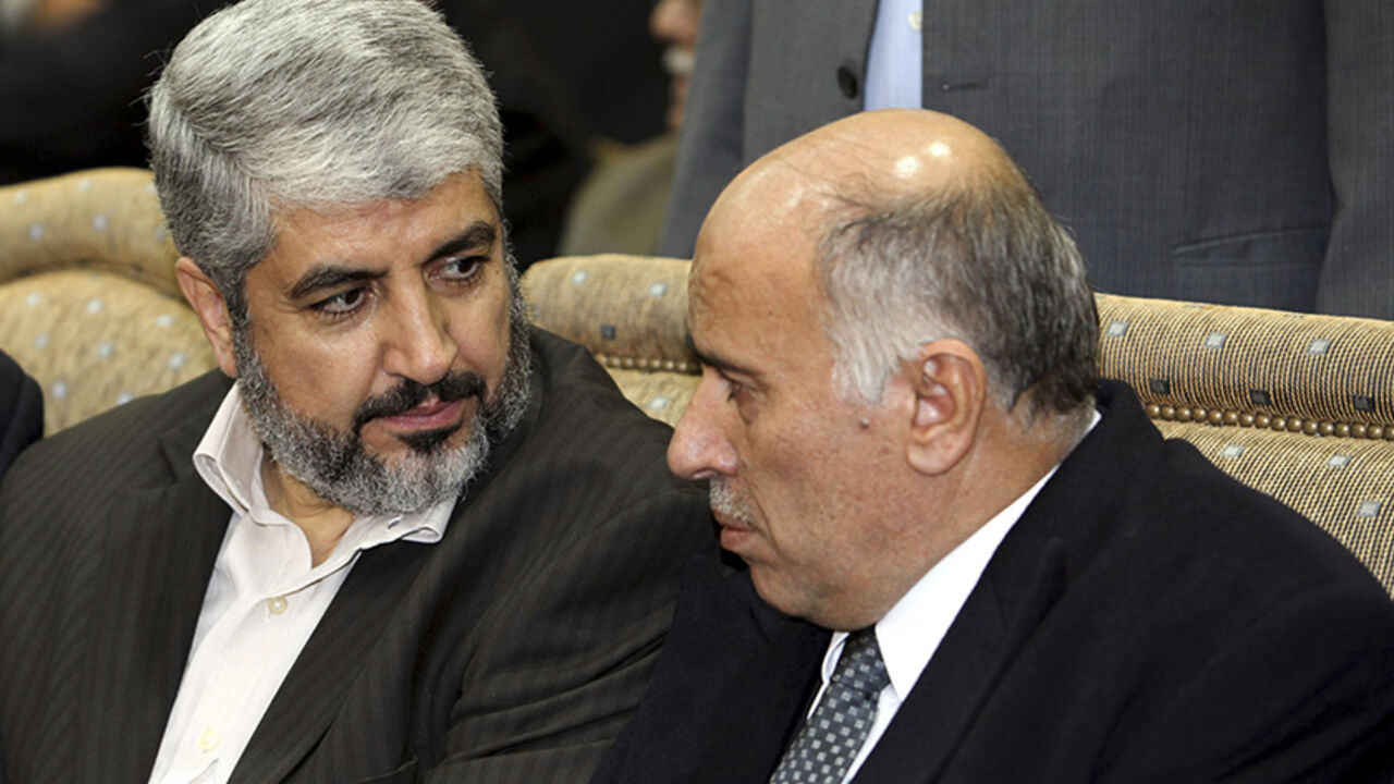 Hamas leader Khaled Meshaal (L) sits beside senior Fatah leader Jibril Rajoub during the wake for Ata Abbas, the older brother of Palestinian President Mahmoud Abbas ,at al-Yarmouk camp near Damascus January 4, 2011. Atta Abbas, approximately 80 years old, died on Sunday of natural causes, according to a Hamas official. REUTERS/Hamas/Handout   (SYRIA - Tags: POLITICS OBITUARY)  FOR EDITORIAL USE ONLY. NOT FOR SALE FOR MARKETING OR ADVERTISING CAMPAIGNS. THIS IMAGE HAS BEEN SUPPLIED BY A THIRD PARTY. IT IS D