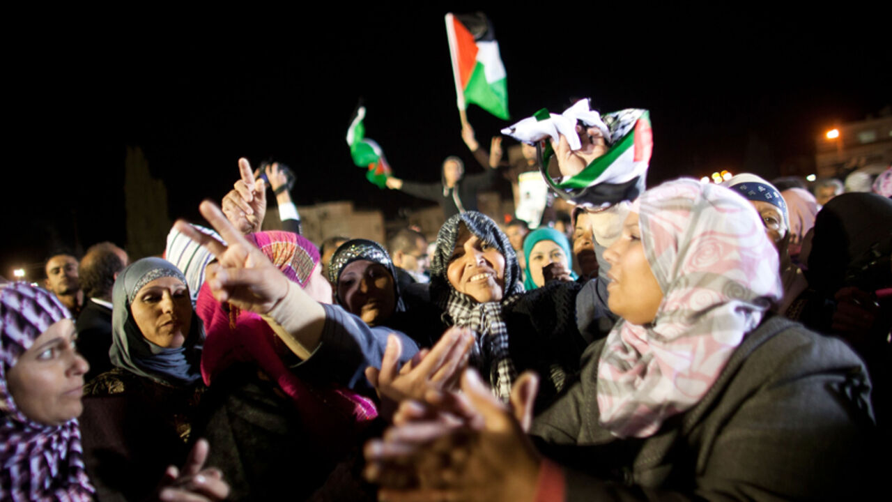 RAMALLAH, WEST BANK - DECEMBER 18: (ISRAEL OUT) Palestinians celebrate as they wait for the release of Palestinian prisoners on December 18, 2011 in Ramallah, West Bank. Israel released 550 Palestinian prisoners to complete a swap deal which brought about the release of captive soldier Gilad Shalit. (Photo by Uriel Sinai/Getty images)