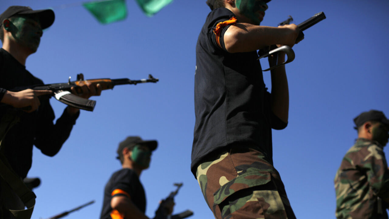 Palestinian youth take part in military exercises during a graduation ceremony as part of a training camp run by the Hamas movement on January 29, 2015 in Gaza City.  AFP PHOTO / MOHAMMED ABED        (Photo credit should read MOHAMMED ABED/AFP/Getty Images)
