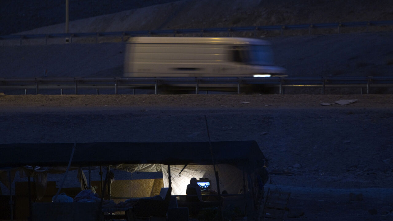 Bedouins of the Jahalin tribe watch television at their encampment, al-Khan al-Ahmar, in the Judean desert close to the road between Jericho and Jerusalem June 16, 2012. Bedouin tents and wandering goats dot the barren hills on the drive from Jerusalem down to the Dead Sea. But the Bedouin tradition is slowly dying out as Israel clears the camps to make way for expanding Jewish urban settlements. Picture taken June 16, 2012. To match Feature PALESTINIANS-ISRAEL/BEDOUIN .REUTERS/Darren Whiteside (WEST BANK -