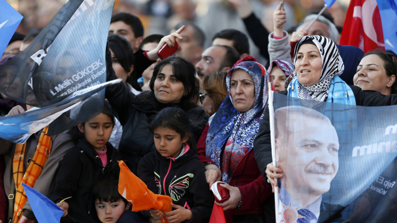 Supporters of Turkey's Prime Minister Tayyip Erdogan wave his portraits and Turkish and his ruling Ak Party (AKP) flags during an election rally in Ankara March 22, 2014. Turks faced fresh difficulties in accessing the Internet on Saturday after the government blocked access to Twitter, the site where tweets on a corruption scandal have angered Prime Minister Tayyip Erdogan. Twitter was blocked late on Thursday, hours after Erdogan vowed to "wipe out" the social media service. Leading international condemna