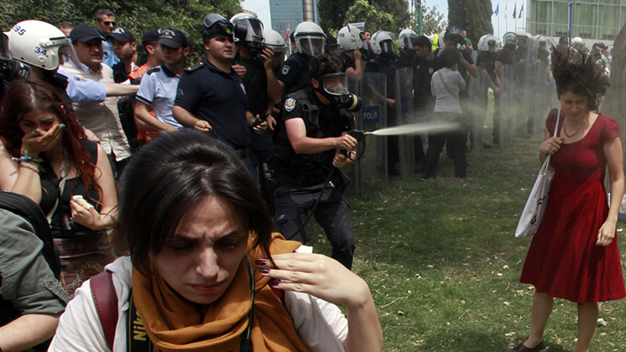 A Turkish riot policeman uses tear gas as people protest against the destruction of trees in a park brought about by a pedestrian project, in Taksim Square in central Istanbul in this May 28, 2013 file photo.  

Osman Orsal: I was covering protests in Istanbul which began as a demonstration against government plans to demolish a small park in central Taksim square but evolved into one the biggest anti-government protests in over a decade.

I was standing between the protesters and the police as the police b