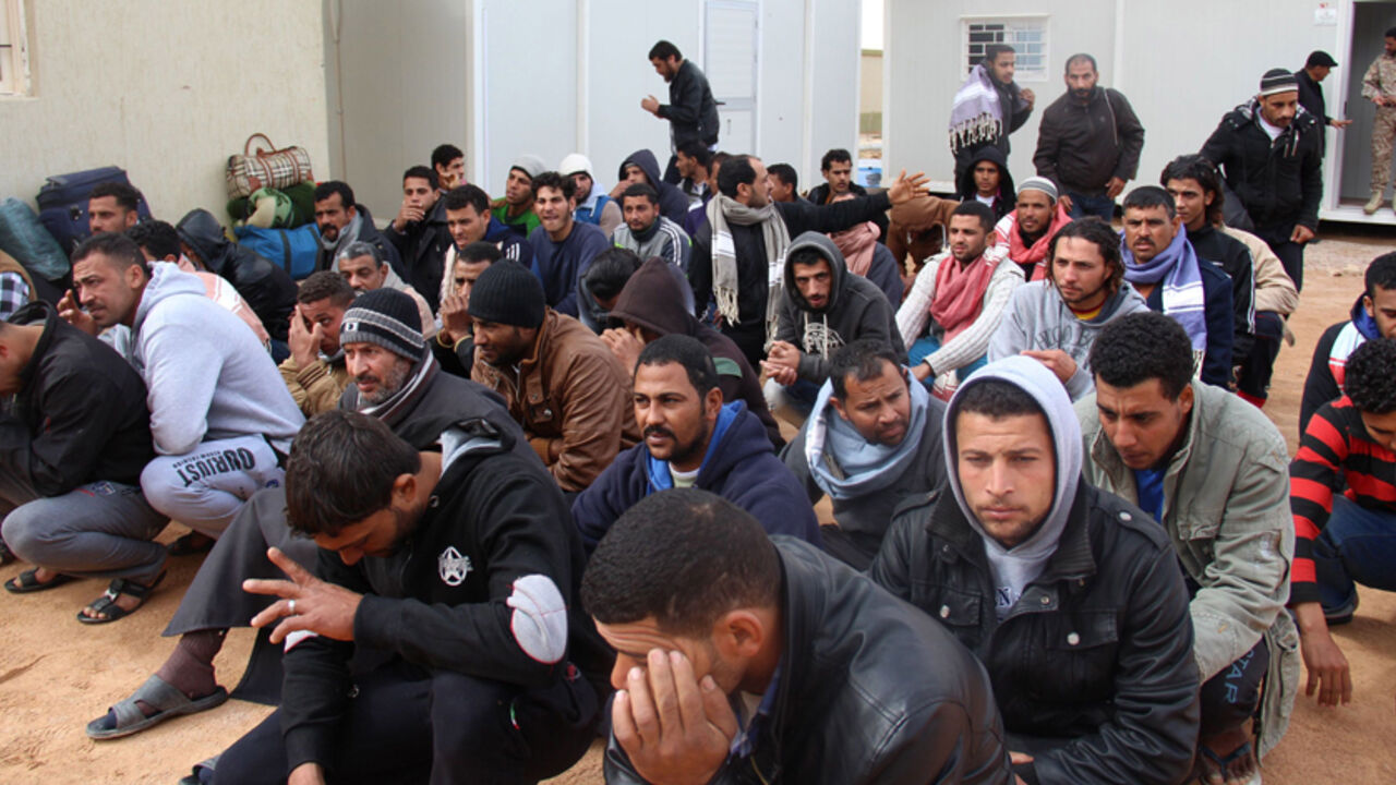 A group of Egyptian illegal immigrants, who according to authorities will be deported back to Egypt through the border with Tunisia on Wednesday, are seen being held at the Alkarareem immigration centre in the east of Misrata February 18, 2015. REUTERS/Stringer (LIBYA - Tags: POLITICS SOCIETY IMMIGRATION) - RTR4Q60O