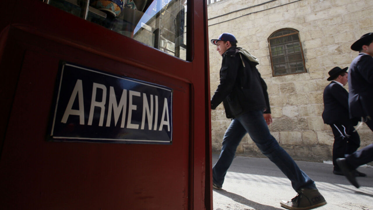 Tourists and Israelis walk past Lepejian ceramics shop, which specializes in making traditional hand painted Armenian pottery, on April 17, 2015 at the Armenian Quarter in Jerusalem's Old City. Armenians around the world will mark on April 24, 2015 the centenary of the World War I-era mass killings of their kin by Ottoman Turks in what they insist was a genocide -- a term fiercely rejected by Turkey. AFP PHOTO / GALI TIBBON        (Photo credit should read GALI TIBBON/AFP/Getty Images)