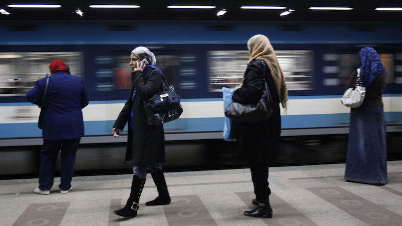 A woman speaks on the phone at a metro station in Cairo February 14, 2011.  REUTERS/Asmaa Waguih (EGYPT - Tags: SOCIETY TRANSPORT) - RTR2IKY5