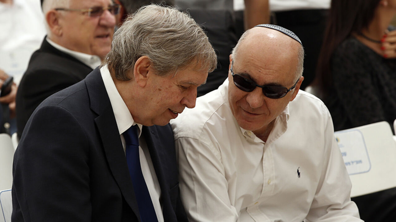 Tamir Pardo (L), head of Israel's spy agency Mossad, and Yoram Cohen, chief of Israel's Shin Bet internal security service, speak during a corner-stone laying ceremony for a memorial commemorating fallen soldiers on Mount Herzl military cemetery in Jerusalem April 30, 2014.  REUTERS/Ronen Zvulun (JERUSALEM - Tags: POLITICS) - RTR3N968