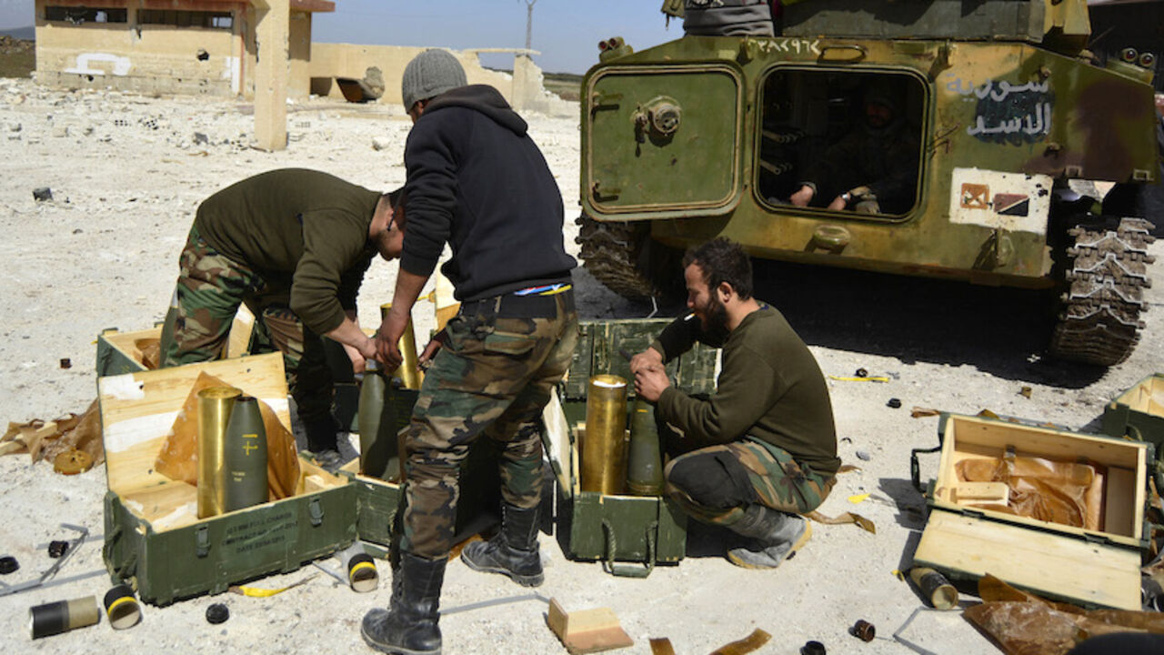 Fighters loyal to Syria's President Bashar Al-Assad go through weapons near a tank after regaining control of Hamreet, a town south of Damascus, in the Daraa countryside March 1, 2015. Government forces say they've regained control of this and many other villages in the south - wresting them back from rebel hands. A general made the announcement on state television, saying a large number of Nusra Front fighters were killed and their weapons destroyed.The gains were said to happen on Friday and Saturday in a
