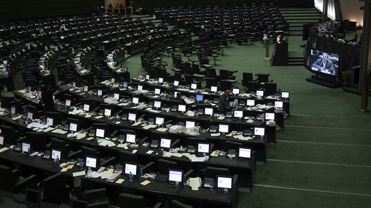 EDITORS' NOTE: Reuters and other foreign media are subject to Iranian restrictions on their ability to film or take pictures in Tehran.
Member of Parliament Mostafa Kavakebian (R) is seen on a screen as he speaks at the parliament in Tehran December 11, 2011. REUTERS/Morteza Nikoubazl (IRAN - Tags: POLITICS) - RTR2V4B5