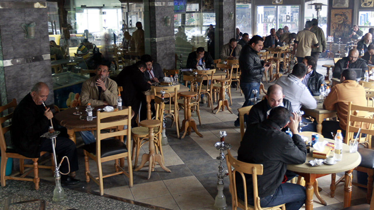 TO GO WITH AFP STORY BY KAMAL TAHA
Men smoke water pipes at a cafe in the Jordanian capital Amman on February 3, 2014. A ban on water pipes in restaurants and cafes has caused uproar in Jordan where $1 billion worth of tobacco goes up in smoke every year.  Under a decision based on a 2008 law that was not previously enforced, the government has announced that by the end of 2014 the licences of more than 5,000 establishments that serve hookahs will be revoked. AFP PHOTO/KHALIL MAZRAAWI        (Photo credit s