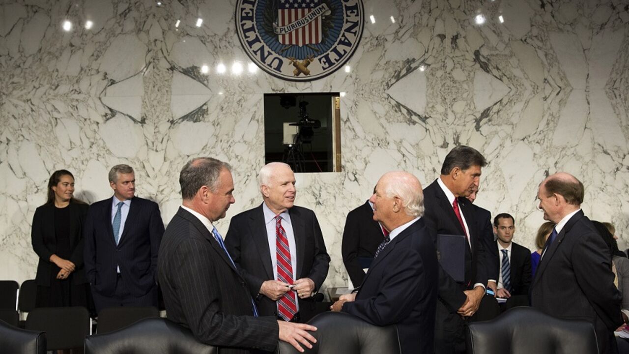 Senators John McCain (R-AZ) (center), Tim Kaine (D-VA) and Ben Cardin (D-MD) (right) speak before Chairman of the Joint Chiefs General Martin E. Dempsey, John Kerry, U.S. secretary of state, and Charles 'Chuck' Hagel, secretary of defense, arrive to present the administration's case for U.S. military action against Syria to a Senate Foreign Relations Committee hearing on September 3, 2013. President Barack Obama on Tuesday urged quick congressional action authorizing the use of military force against Syria 