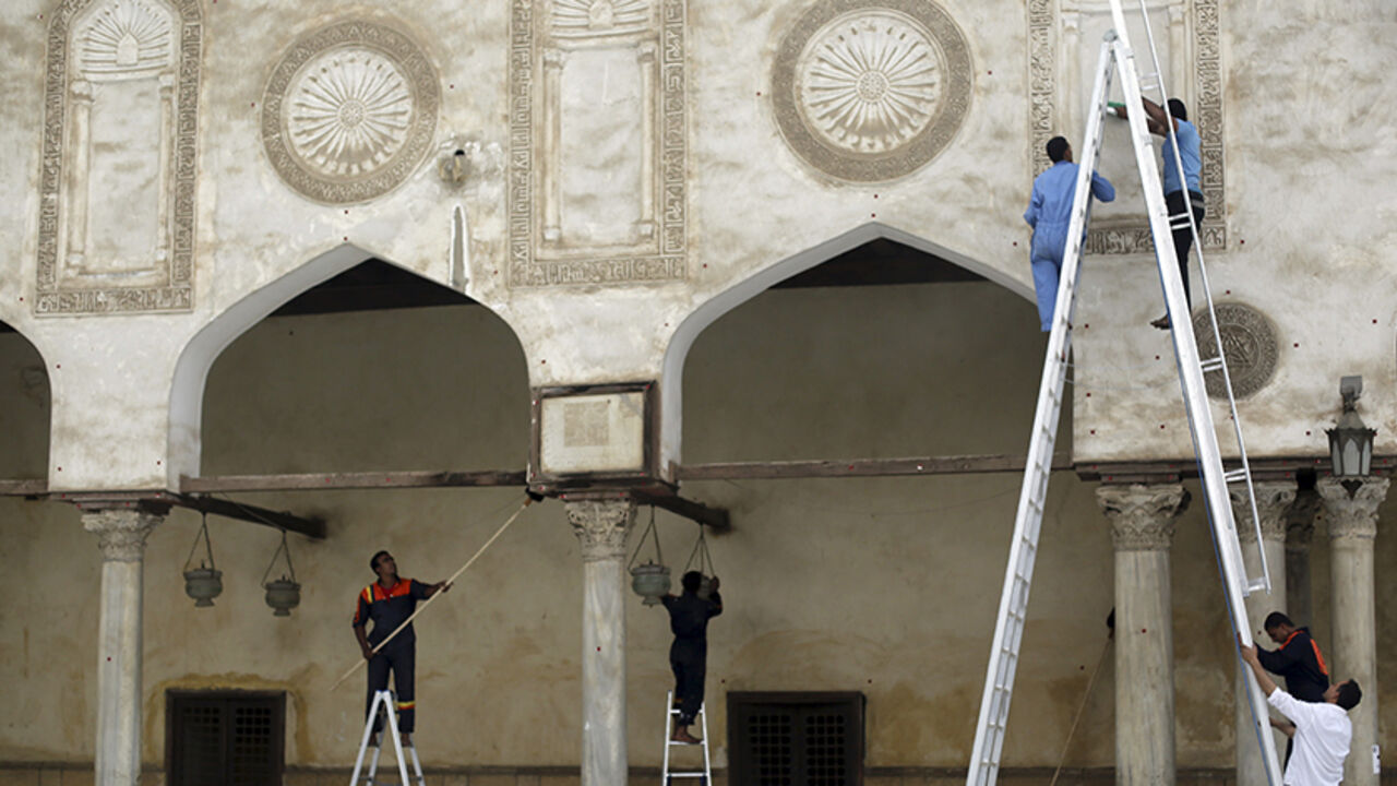 Men carry out cleaning work at Al-Azhar Mosque, in the old Islamic area of Cairo May 8, 2014. As the Egyptian state presses its crackdown on the Muslim Brotherhood, the man expected to become president has deployed a new weapon in the battle with the Islamists: his own vision of Islam. Sisi, the former army chief who deposed the Brotherhood's Mohamed Mursi and is expected to be elected president later this month, has cast himself as a defender of religion and taken aim at the doctrinal foundations of Islami
