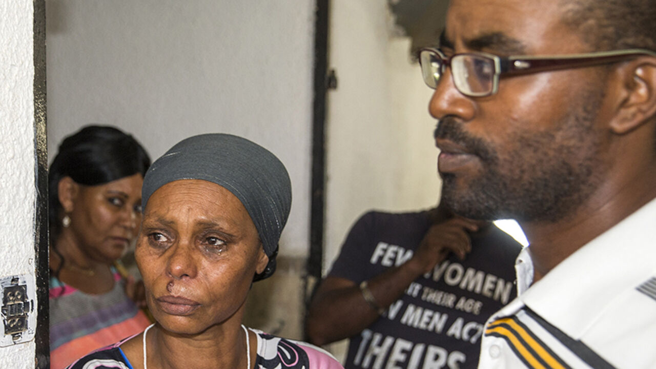 The brother and mother of Avraham Mengistu, 29, an Israeli of Ethiopian descent who is reportedly held captive in the Gaza Strip, stand during a press conference in the southern city of Ashkelon on July 9, 2015, in which they called on Hamas to release his brother and the Israeli government to work toward his safe return. Two Israelis are being held captive in the Gaza Strip, including one detained by Hamas after crossing into the territory last year, Israeli officials said, raising fears of another hostage