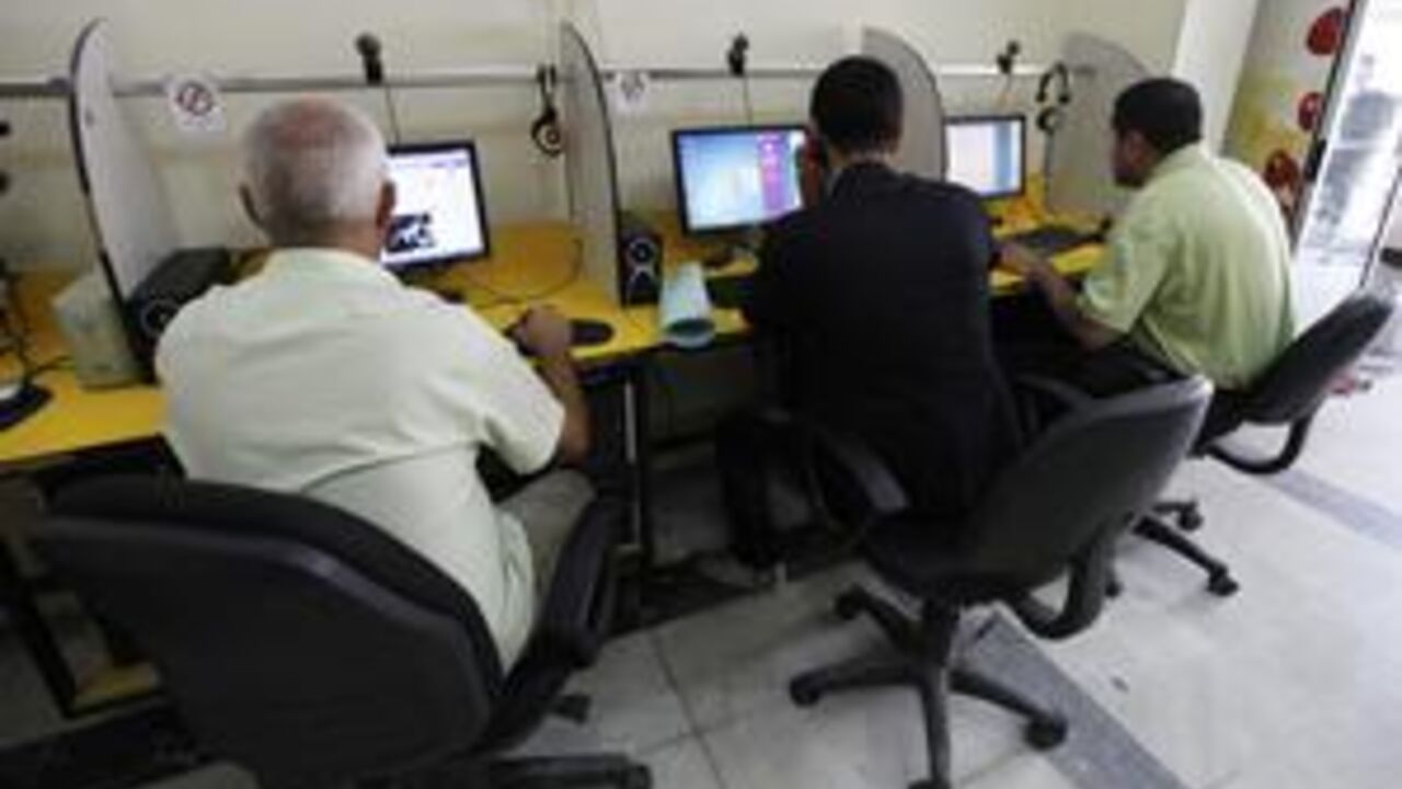 People surf the Internet at an Internet cafe in Baghdad November 11, 2012. Iraqi telecommunications operators have warned that government plans to charge for the extra spectrum which they need to launch long-awaited 3G services could slow Internet adoption and economic growth. Picture taken November 11, 2012. To match story IRAQ-TELECOMS/  REUTERS/Mohammed Ameen (IRAQ - Tags: BUSINESS TELECOMS SCIENCE TECHNOLOGY SOCIETY)