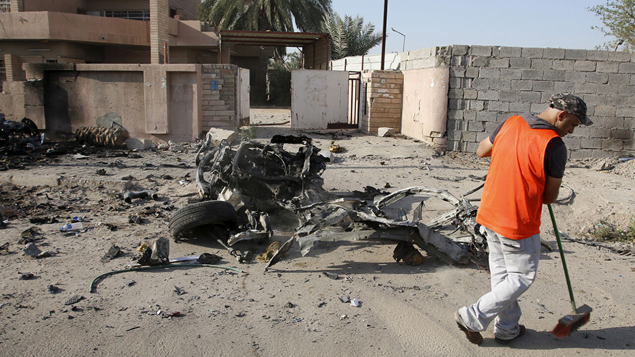 A municipality worker sweeps the ground at the site of a car bomb attack in Baghdad July 13, 2015. Car bombs and suicide attacks targeting mainly Shi'ite Muslim districts of Baghdad killed 35 people on Sunday, one of the heaviest recent tolls in the Iraqi capital, which has faced a wave of bombings by Islamic State militants.  REUTERS/Khalid al-Mousily 

 - RTX1K6JG