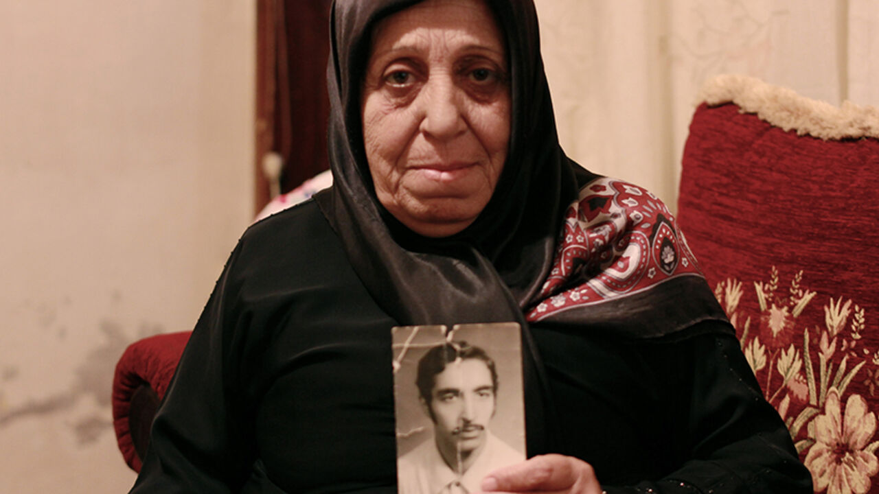 Fatima Rida holds a photo of her Missing Husband, Hussein Moalim who disappeared during Lebanon's civil war in March 1976. 