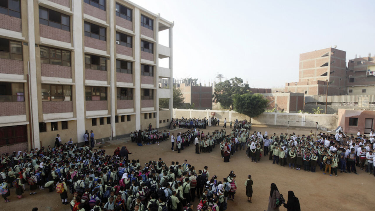 Students line up on the first day of their new school year at a government school in Giza, south of Cairo September 22, 2013. Students resumed their studies at the beginning of the new academic year this weekend amid parental concerns of a possible lack of security after the summer vacation ends. REUTERS/Mohamed Abd El Ghany  (EGYPT - Tags: POLITICS EDUCATION) - RTX13UIT