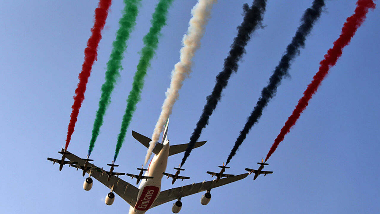 United Arab Emirates' Air Force Aerobatic Team, Al-Fursan, performs with an Emirates Airline's Airbus A380 at the Dubai Airshow on November 18, 2013, in Dubai. Emirates Airline's appetite for aircraft purchases will not cease, the airline's president Tim Clark told AFP a day after the Dubai-based carrier ordered 200 planes from Boeing and Airbus. AFP PHOTO/MARWAN NAAMANI        (Photo credit should read MARWAN NAAMANI/AFP/Getty Images)