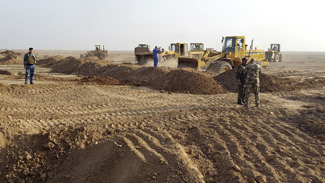 People operate heavy machinery during the building of a new road between Diyala province and Samarra December 21, 2014.  A Shi'ite paramilitary organization is constructing a road to strengthen its positions across the mixed areas of Diyala and neighbouring Salahuddin province. The Badr Organization, a leading political party and militia with ties to Iran, is supervising the new road, which leads to Samarra. It means Badr can resupply troops guarding Samarra, currently surrounded by Islamic State, and the 3