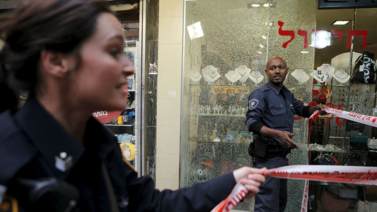 Israeli police officers cordon off the scene of a shooting incident in Tel Aviv, Israel January 1, 2016. One person was killed and several were wounded in a shooting incident in central Tel Aviv on Friday, Israeli media said. A police spokesman confirmed there had been several casualties but would not say if anyone was killed in the incident on Dizengoff Street. REUTERS/Nir Elias  - RTX20PRI