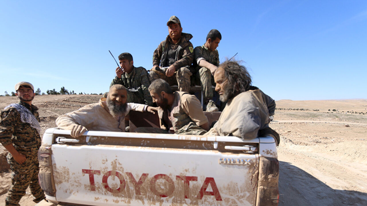 Three men that Democratic Forces of Syria fighters claimed were Islamic State fighters sit on a pick-up truck while being held as prisoners, near al-Shadadi town, Hasaka countryside, Syria, February 18, 2016.  REUTERS/Rodi Said - RTX27LV4