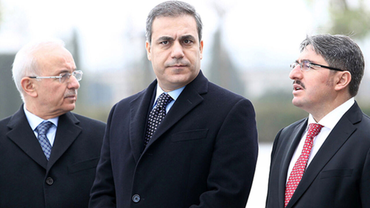 This file picture taken on December 19, 2014 shows the head of Turkey's intelligence agency Hakan Fidan (C) standing in Ankara. The powerful head of Turkey's intelligence agency, one of the most loyal allies of President Recep Tayyip Erdogan, has resigned to stand for election as a lawmaker, the official Anatolia news agency said on February 7, 2015. The resignation of Hakan Fidan, who has headed the National Intelligence Agency (MIT) since 2010, has been accepted by Prime Minister Ahmet Davutoglu and will 