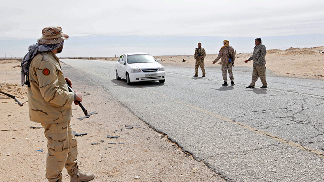 Libyan soldiers manning a military outpost, stop a car at a checkpoint in Wadi Bey, west of the city of Sirte, which is held by Islamic State militants, February 23, 2016. REUTERS/Ismail Zitouny - RTX28A55