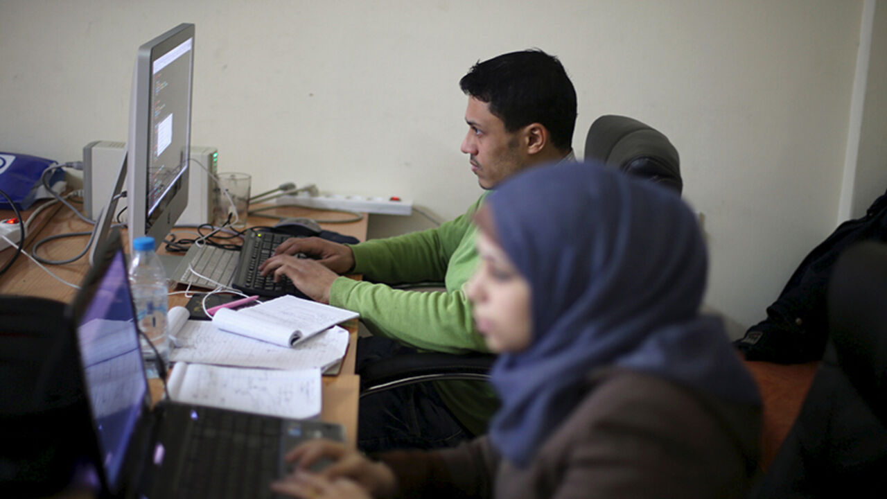 Young Palestinian entrepreneurs use their computers at Gaza Sky Geeks office, in Gaza City January 18, 2016. Picture taken January 18, 2016. REUTERS/Ibraheem Abu Mustafa  - RTX242SL