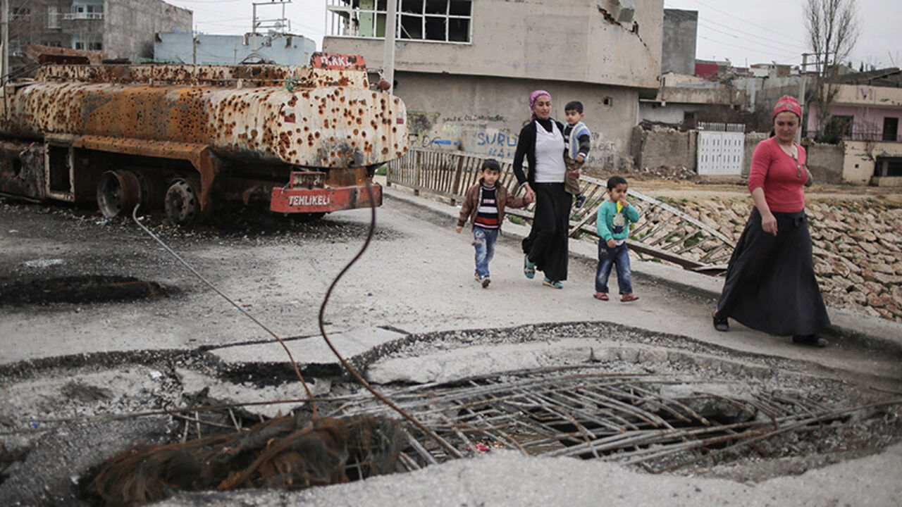 NUSAYBIN, TURKEY -  FEBRUARY 25:  Residents walk past the trenches of the armed group Patriotic Revolutionary Youth Movement (YDG-H), a youth division of the Kurdistan Workers' Party, PKK, in southeastern Turkish city of Nusaybin on February 25, 2016, Turkey. Since mid-December, the Turkish security forces placed to several predominantly Kurdish cities in Turkey under 24-hour martial law and curfew on the premise of restoring public order. (Photo by Cagdas Erdogan/Getty Images)