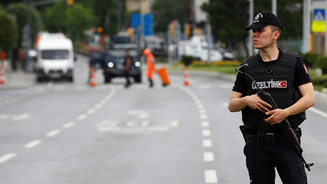A police officer stands guard near the site where a Turkish police bus was targeted in a bomb attack in a central Istanbul district, Turkey, June 7, 2016. REUTERS/Osman Orsal - RTSGDQF
