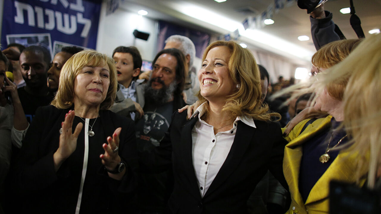 Dr. Aliza Lavie (C), a Yesh Atid (There's a future) party candidate, celebrates exit poll results at the party's headquarters in Tel Aviv January 22, 2013. Israel's parliament, long heavy with retired generals, is getting a new look, with a freshman class that includes two youth protest leaders, an Ethiopian immigrant, a high tech millionaire and more women than ever. Thanks to the surprise second place finish of Yesh Atid, as well as the success of a new far-right group, the 120-member Knesset will have a 