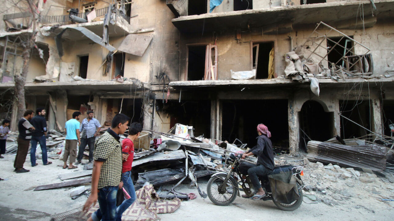 Men inspect damage after an air strike on Aleppo's rebel-held al-Shaar neighbourhood, Syria June 8, 2016. REUTERS/Abdalrhman Ismail - RTSGM5D