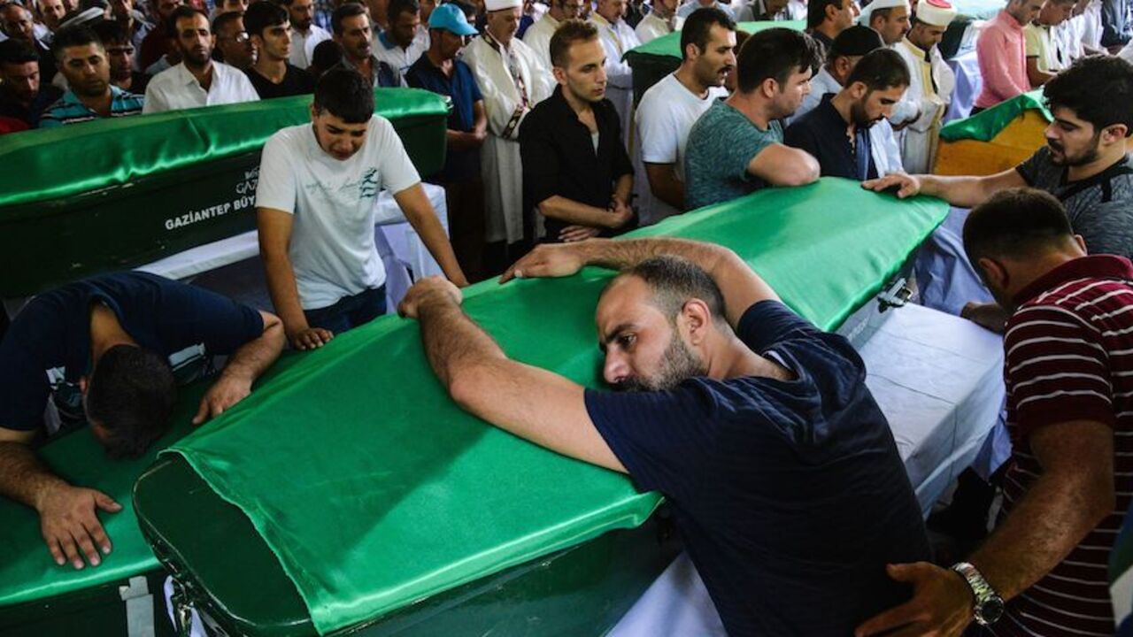 A man bends on a coffin as people mourn during a funeral for victims of last night's attack on a wedding party that left 50 dead in Gaziantep in southeastern Turkey near the Syrian border on August 21, 2016.
At least 50 people were killed when a suspected suicide bomber linked to Islamic State jihadists attacked a wedding thronged with guests, officials said on August 21. Turkish President Recep Tayyip Erdogan said the IS extremist group was the "likely perpetrator" of the bomb attack, the deadliest in 2016