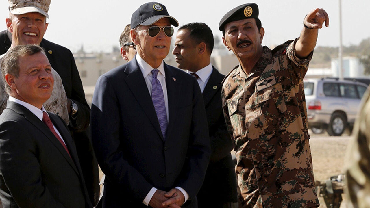 Jordan's King Abdullah (R) and U.S. Vice President Joe Biden (C) listen to Jordanian Chief of Staff General Mashal Mohammad Zaben during their visit to a joint Jordanian-American training center at Zarqa, northeast of Amman, Jordan, March 10, 2016. REUTERS/Muhammad Hamed - RTSA7HN